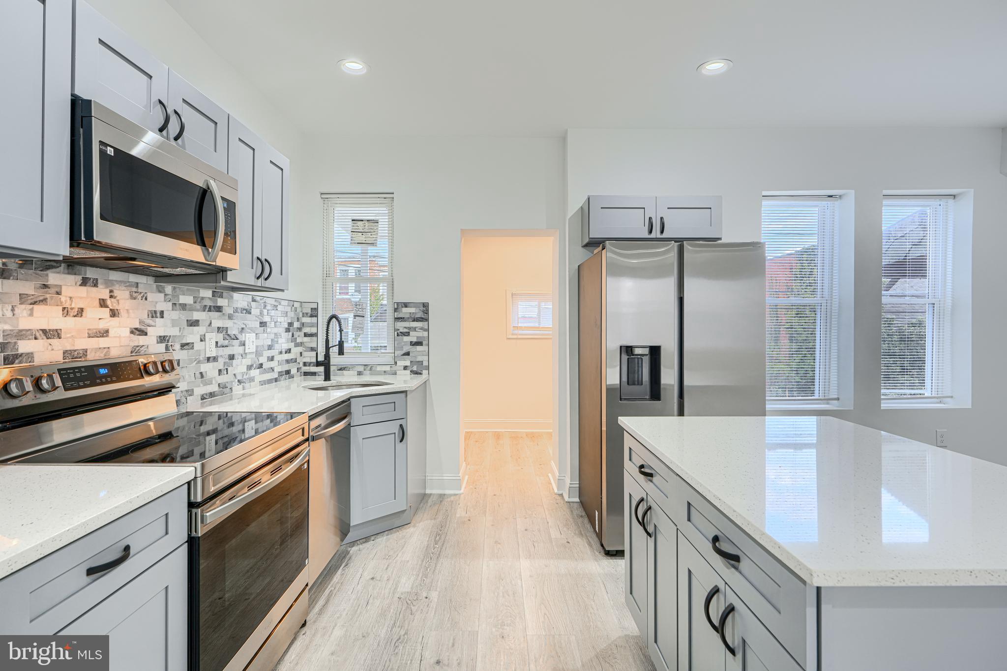 615 Linnard Street Baltimore, MD 21229 - Photo 6 of 28 a kitchen with stainless steel appliances a sink stove and refrigerator
