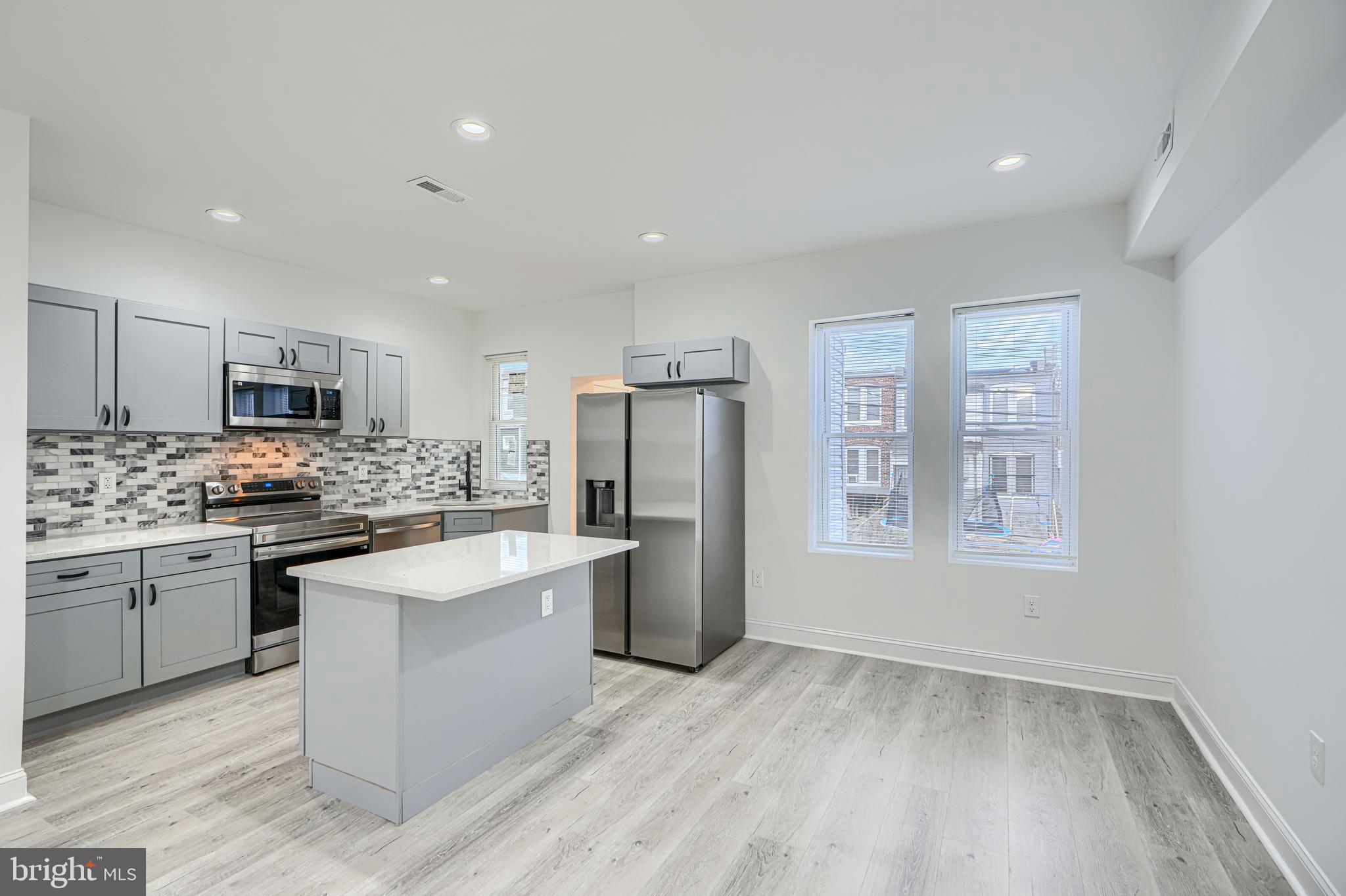 615 Linnard Street Baltimore, MD 21229 - Photo 7 of 28 a kitchen with refrigerator and cabinets