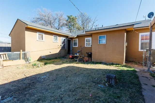 a swimming pool with outdoor seating and yard