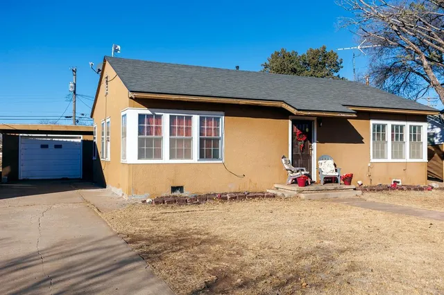 a living room with furniture a couch and a potted plant