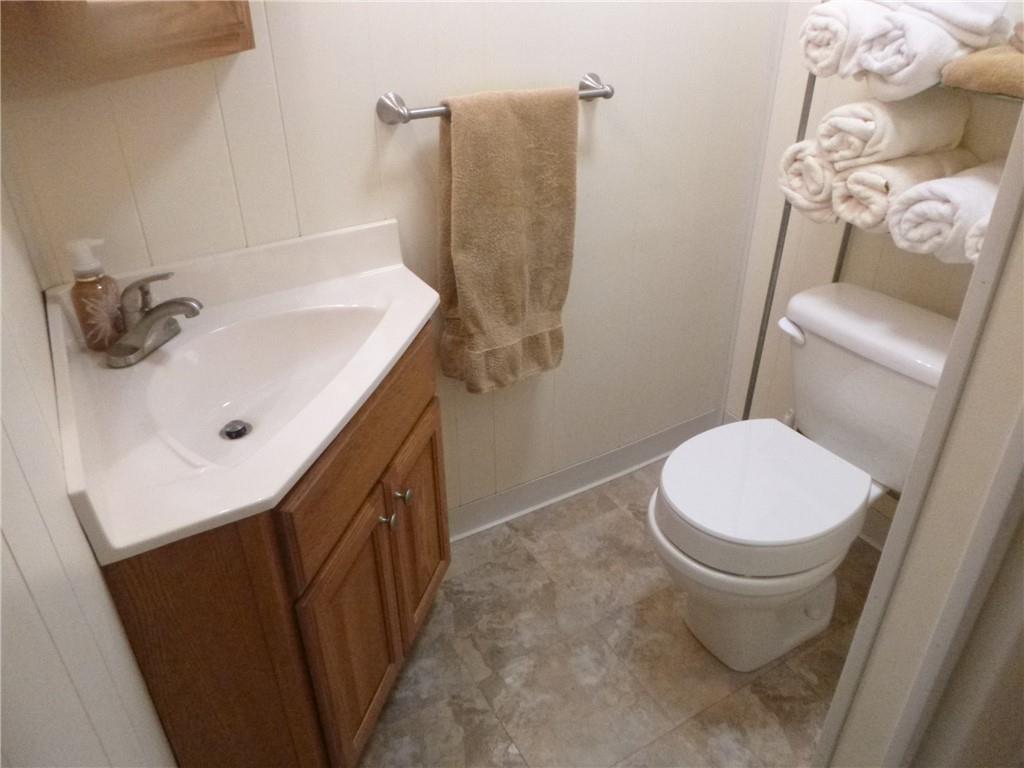 133 Pinto Drive, Unit PINTO DRIVE Plum, PA 15239 - Photo 20 of 21 a bathroom with a sink a toilet and mirror