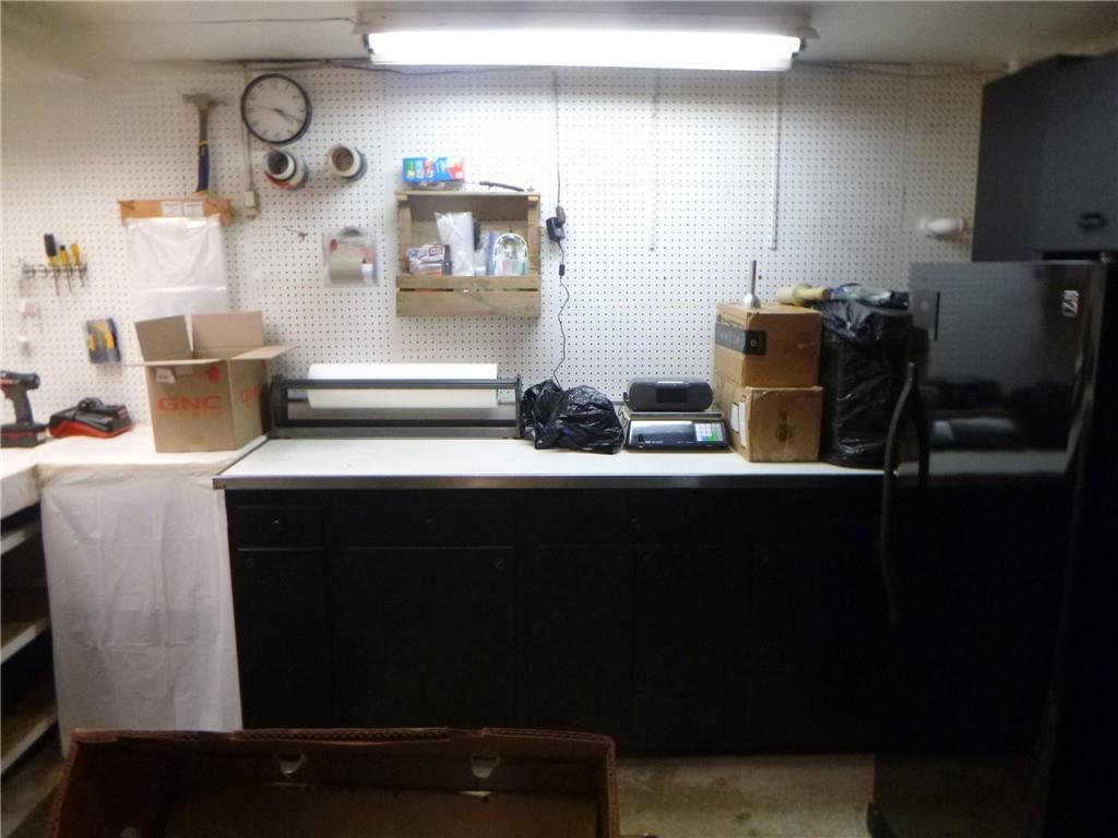 133 Pinto Drive, Unit PINTO DRIVE Plum, PA 15239 - Photo 21 of 21 a kitchen with stainless steel appliances wooden cabinets and a table