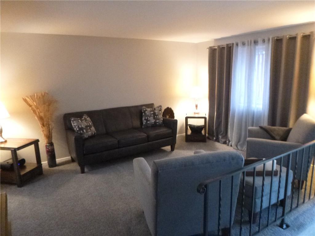 133 Pinto Drive, Unit PINTO DRIVE Plum, PA 15239 - Photo 7 of 21 a living room with furniture and a lamp