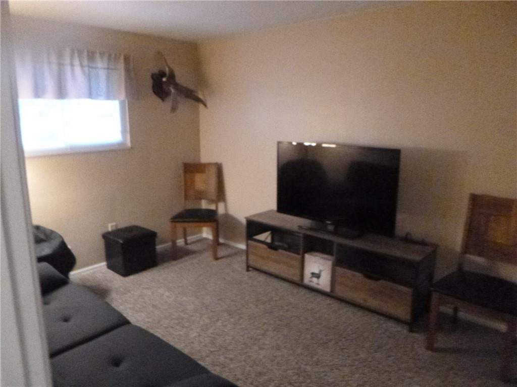 133 Pinto Drive, Unit PINTO DRIVE Plum, PA 15239 - Photo 8 of 21 a living room with furniture and a flat screen tv