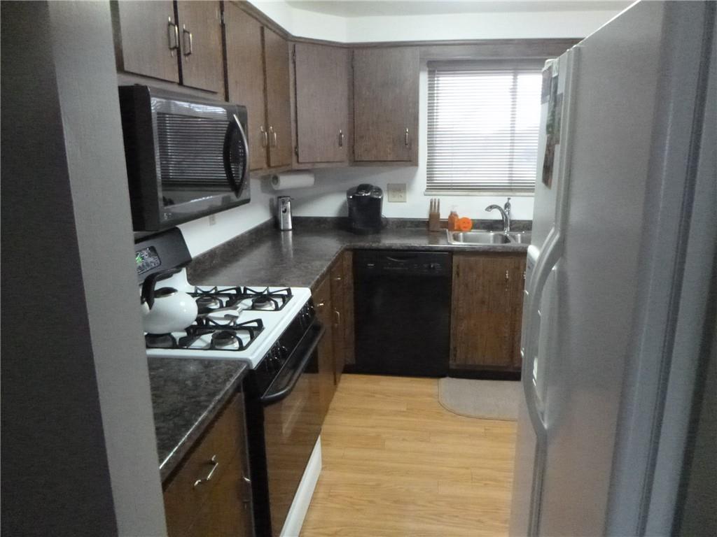 133 Pinto Drive, Unit PINTO DRIVE Plum, PA 15239 - Photo 10 of 21 a kitchen with a sink and a stove top oven