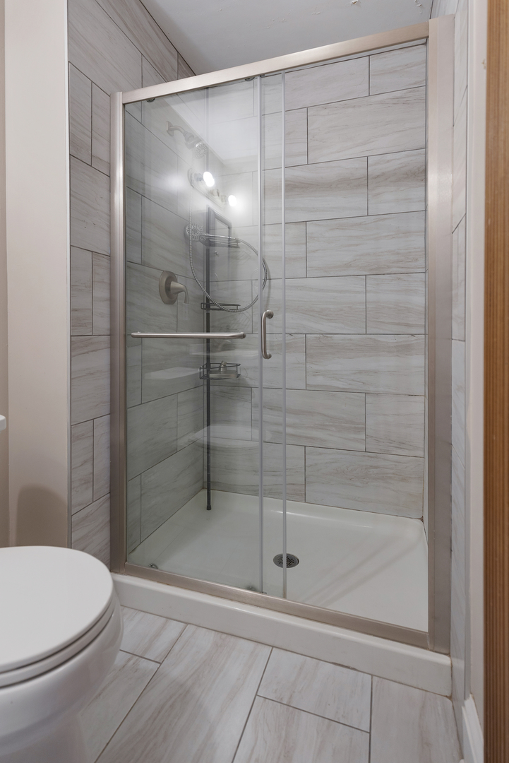 222 West Main Street, Unit A St. Charles, IL 60174 - Photo 17 of 17 a bathroom with a shower a toilet and a sink