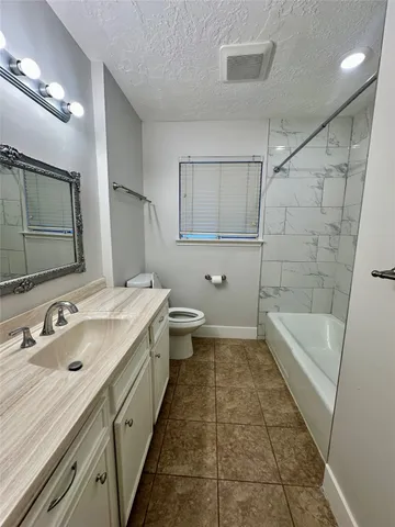 a bathroom with a sink a toilet and bathtub