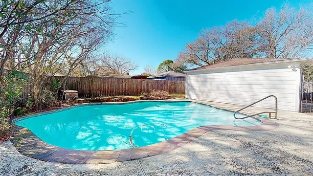 a view of a swimming pool with a patio