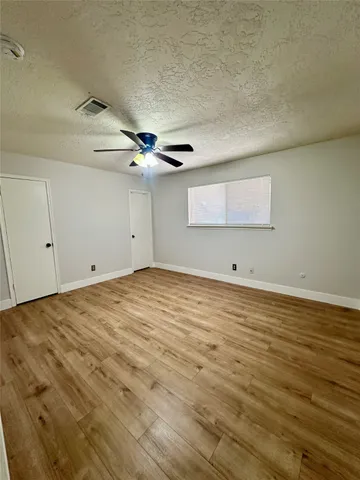 a view of a room with wooden floor