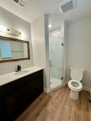 a bathroom with a sink toilet a mirror and shower