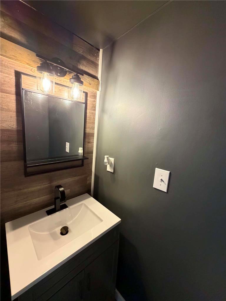 164 Sand Spring Road Cresco, PA 18326 - Photo 51 of 60 Modern vanity with vessel sink and industrial lighting fixtures elevate this well-appointed washroom.