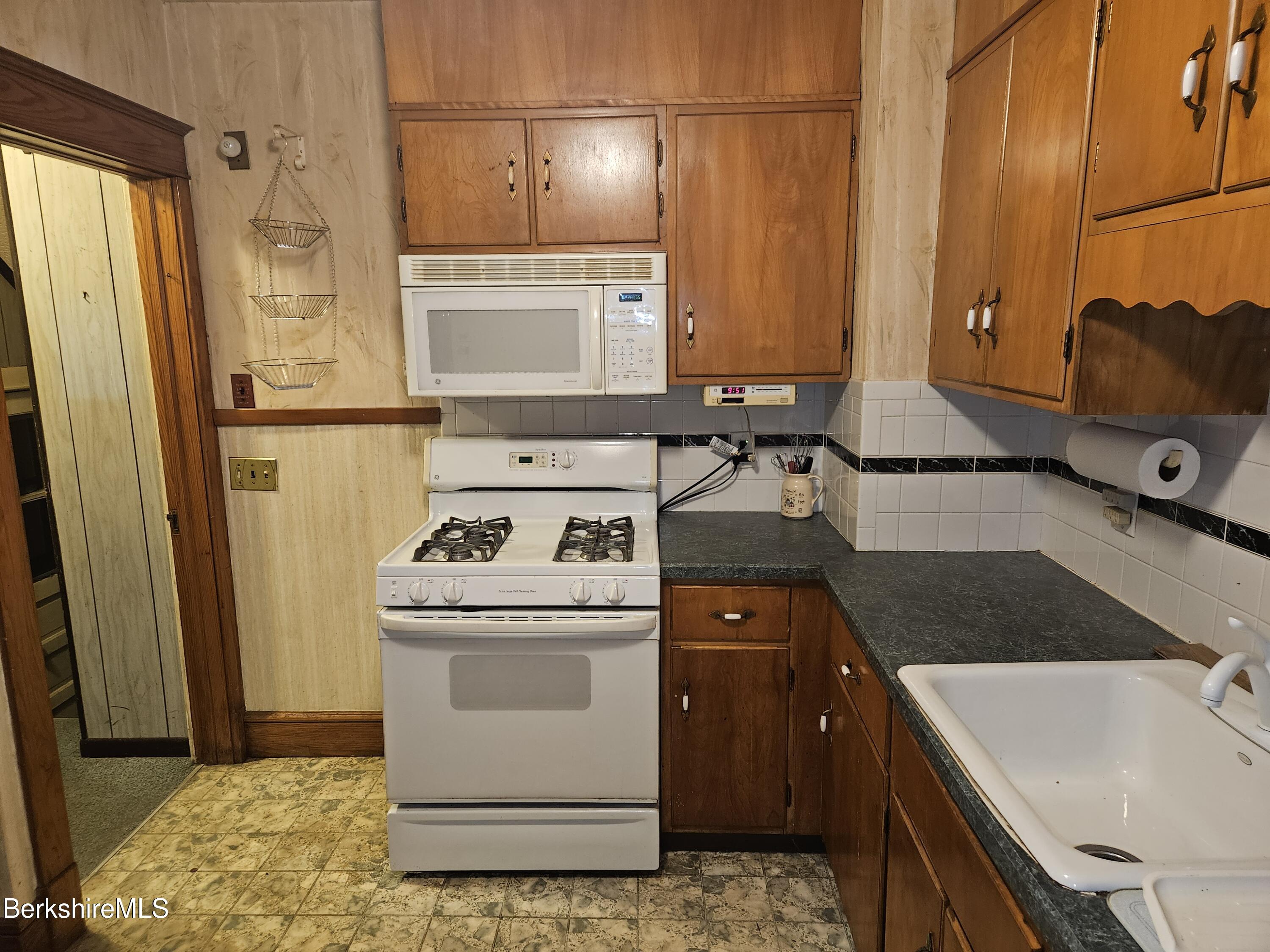 269 2nd Street Pittsfield, MA 01201 - Photo 17 of 39 a kitchen with a sink stove and refrigerator