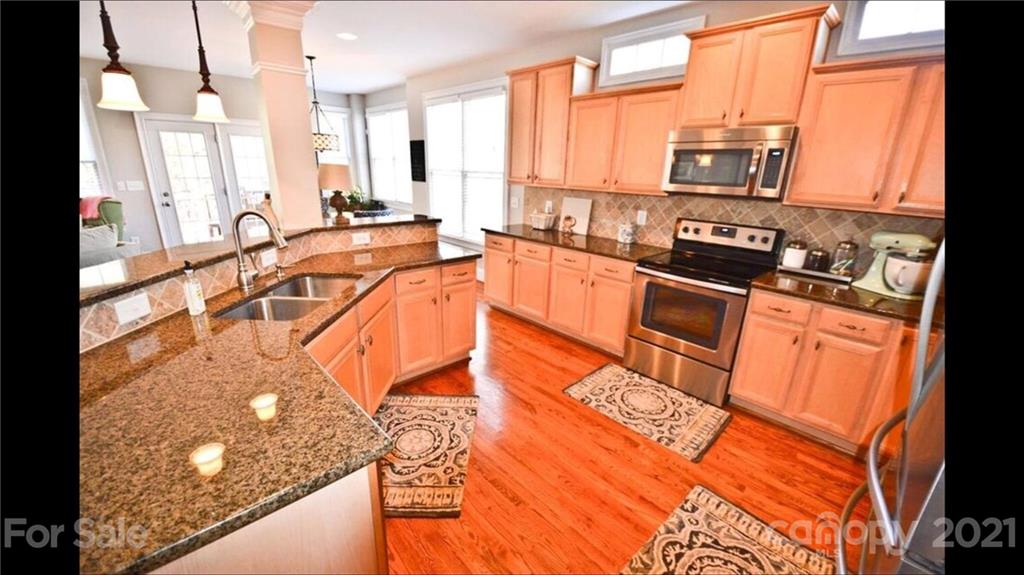 882 Stratford Run Drive Fort Mill, SC 29708 - Photo 2 of 4 a kitchen with stainless steel appliances granite countertop a sink a stove and a microwave