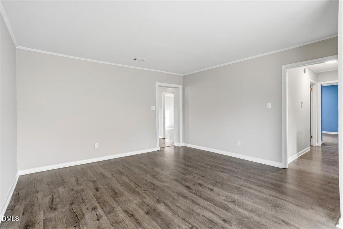 713 Friar Tuck Road Raleigh, NC 27610 - Photo 12 of 29 a view of an empty room with wooden floor