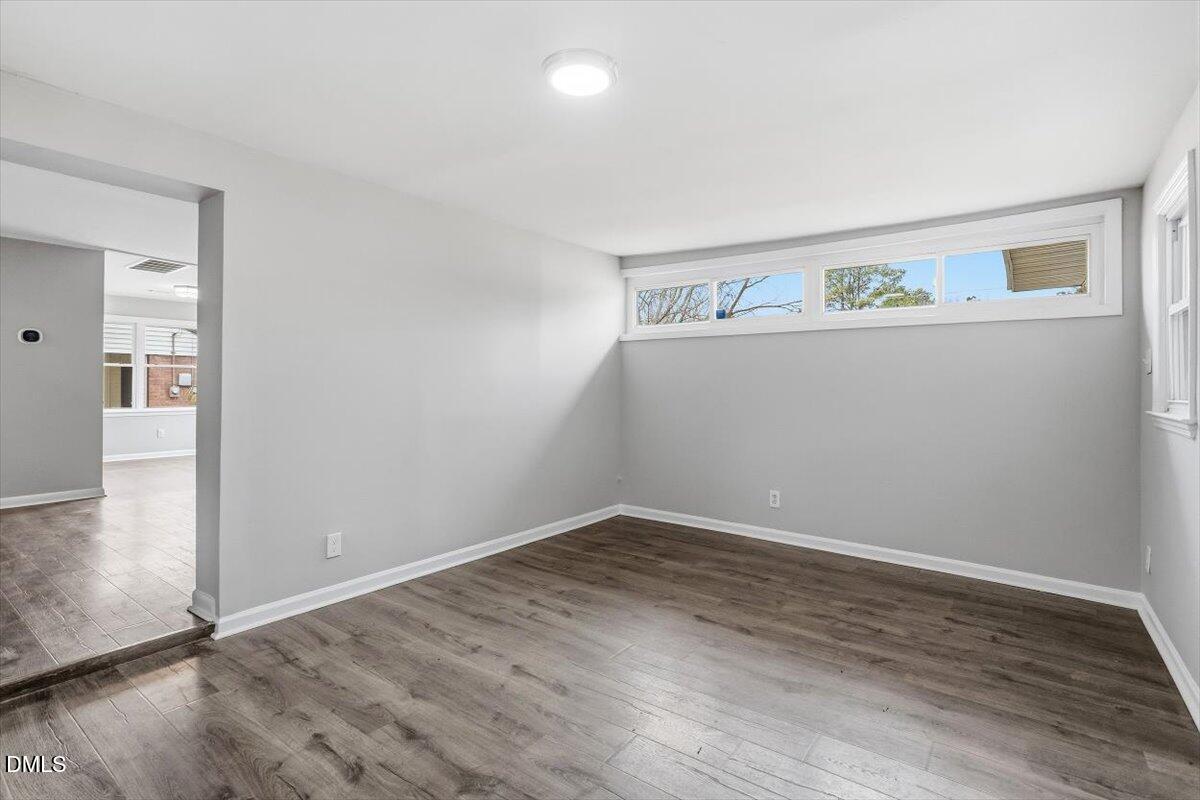 713 Friar Tuck Road Raleigh, NC 27610 - Photo 6 of 29 an empty room with wooden floor