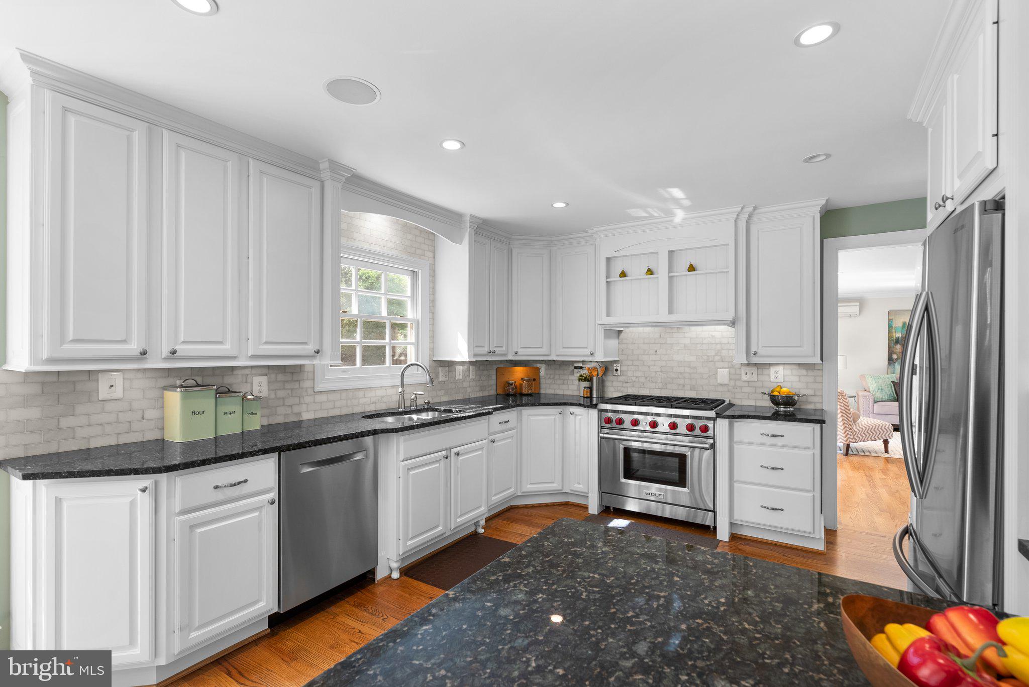 3106 Russell Road Alexandria, VA 22305 - Photo 12 of 62 a kitchen with granite countertop stainless steel appliances a sink and cabinets