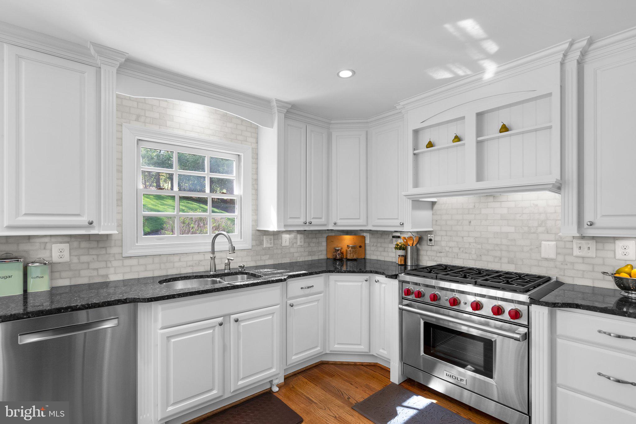 3106 Russell Road Alexandria, VA 22305 - Photo 13 of 62 a kitchen with granite countertop a sink a stove and cabinets