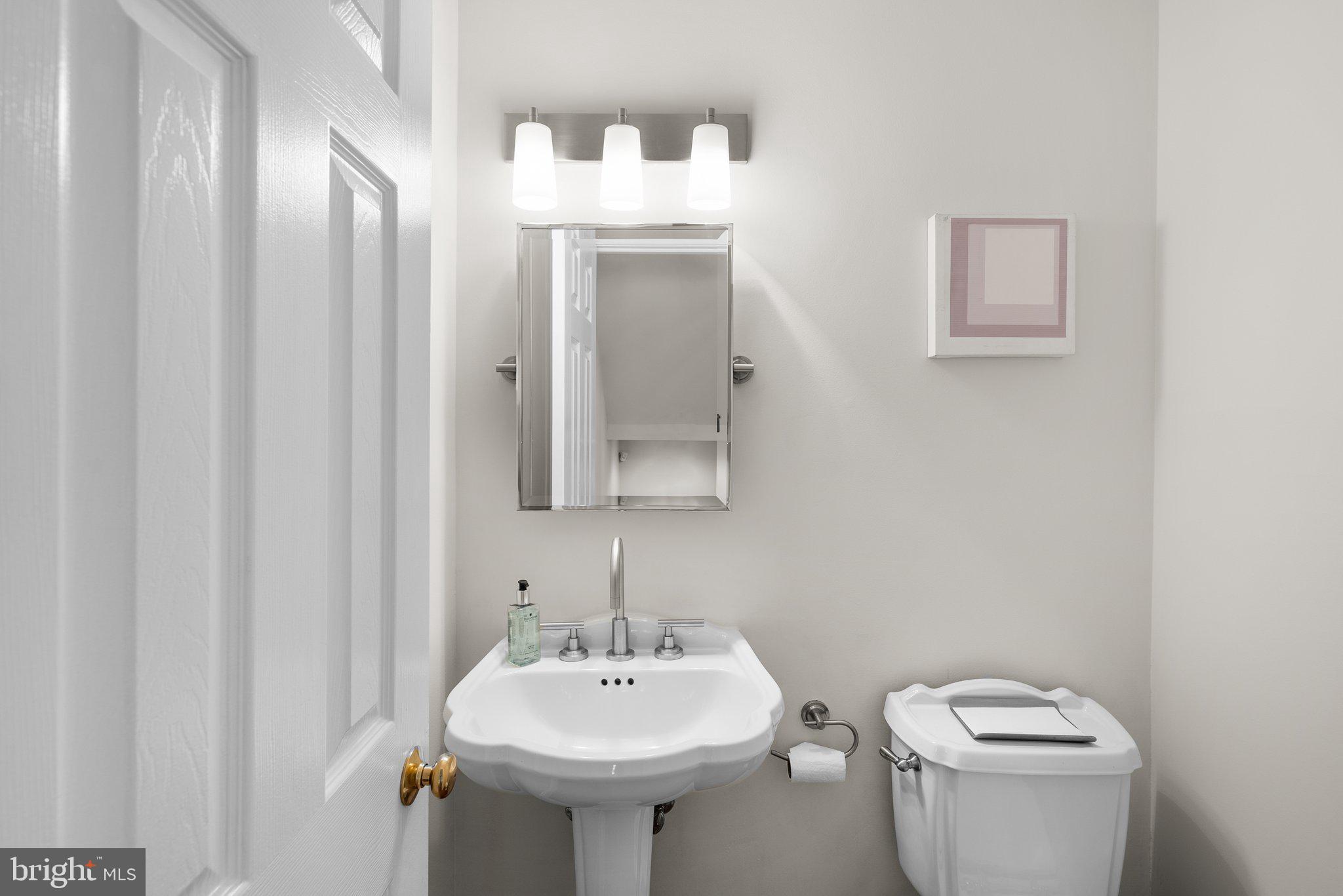 3106 Russell Road Alexandria, VA 22305 - Photo 26 of 62 a bathroom with a toilet sink and mirror