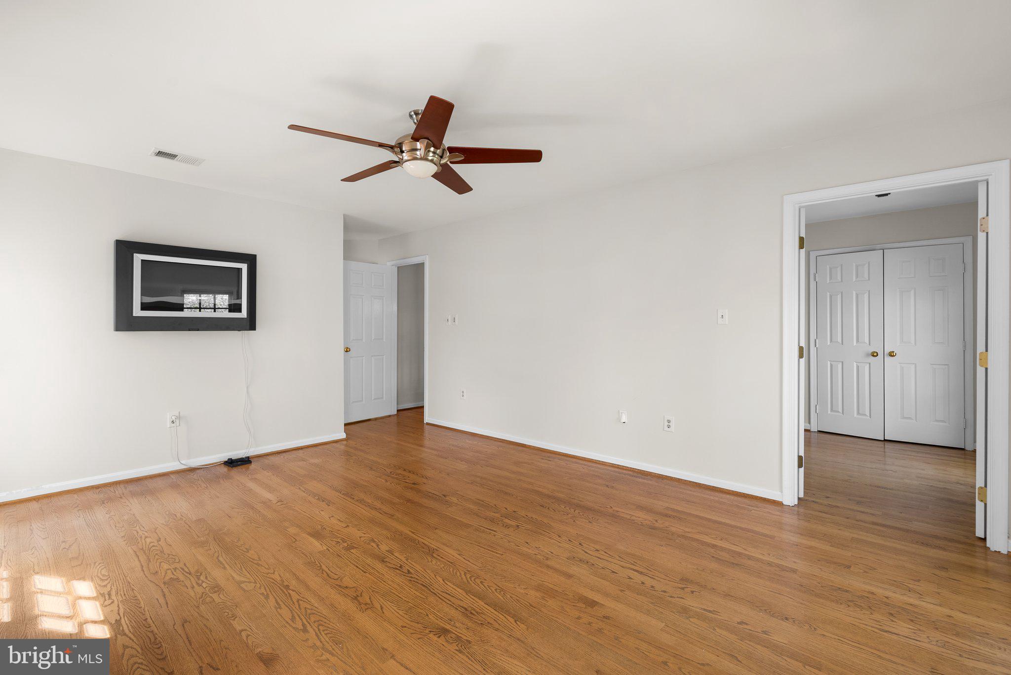 3106 Russell Road Alexandria, VA 22305 - Photo 30 of 62 an empty room with wooden floor and windows