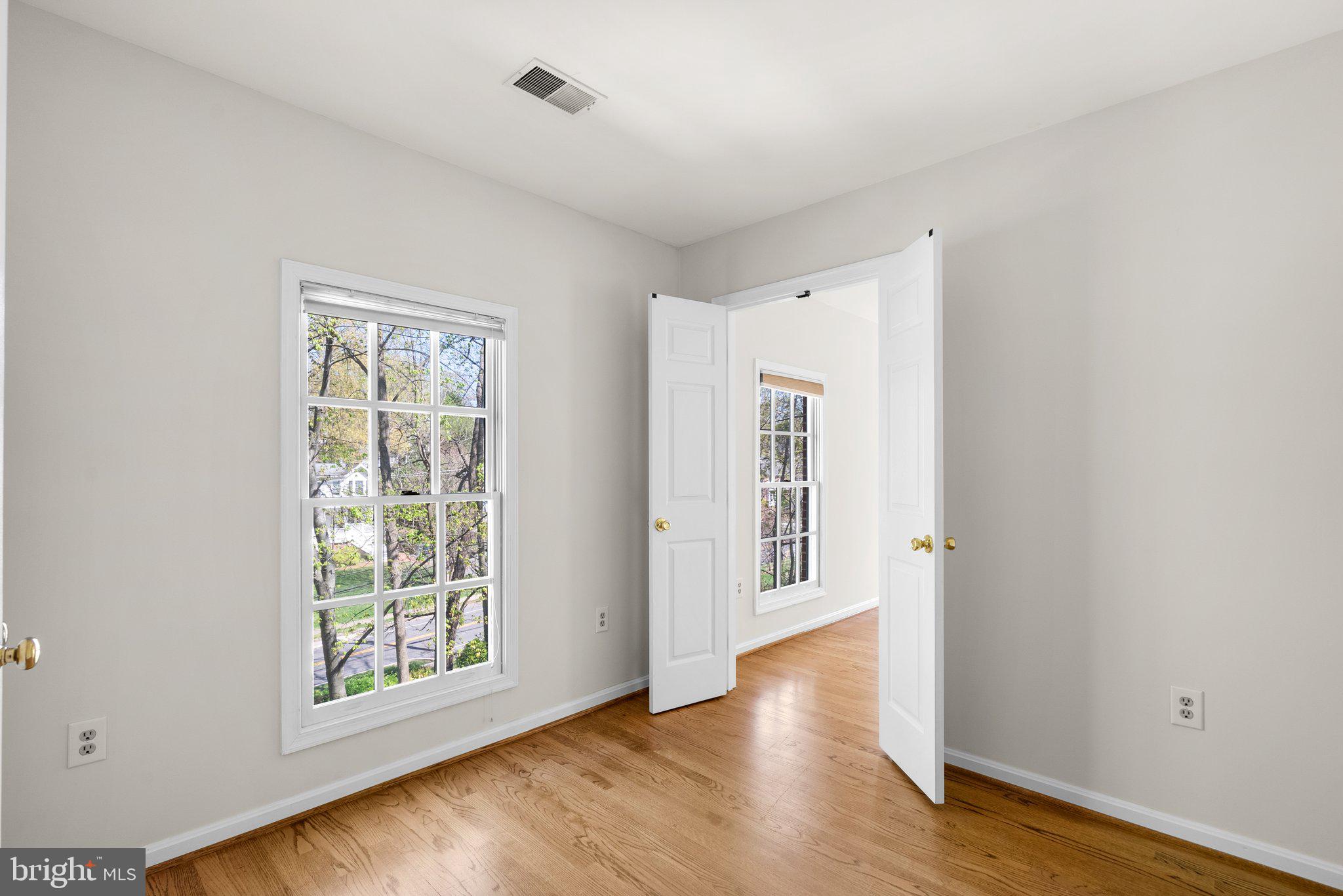 3106 Russell Road Alexandria, VA 22305 - Photo 39 of 62 an empty room with wooden floor and windows
