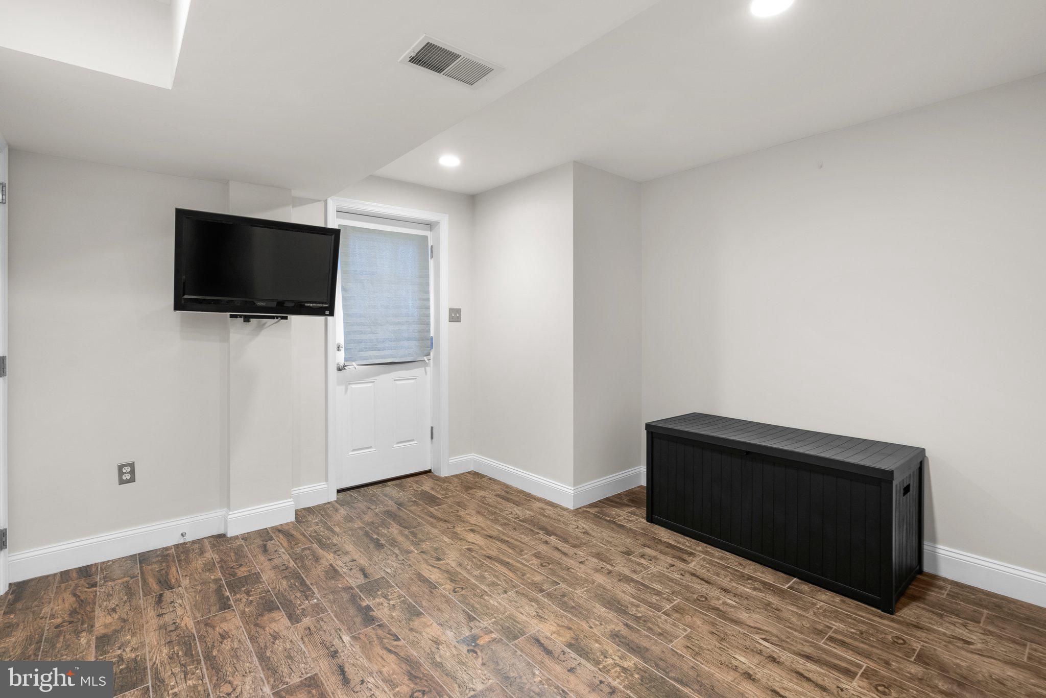 3106 Russell Road Alexandria, VA 22305 - Photo 47 of 62 a bedroom with a bed and a flat screen tv