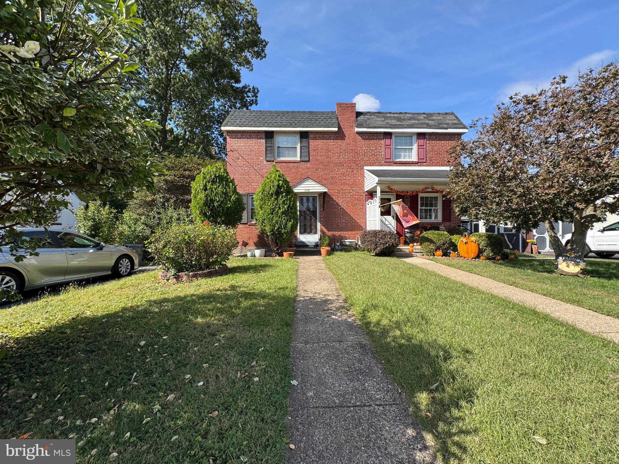 236 Willard Drive Ridley Park, PA 19078 - Photo 2 of 19 a front view of a house with a yard and potted plants