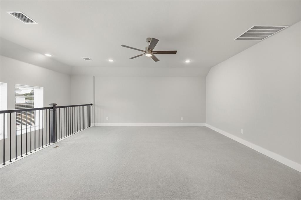 5805 Heatherwood Loop Sachse, TX 75048 - Photo 29 of 39 an empty room with windows and fan