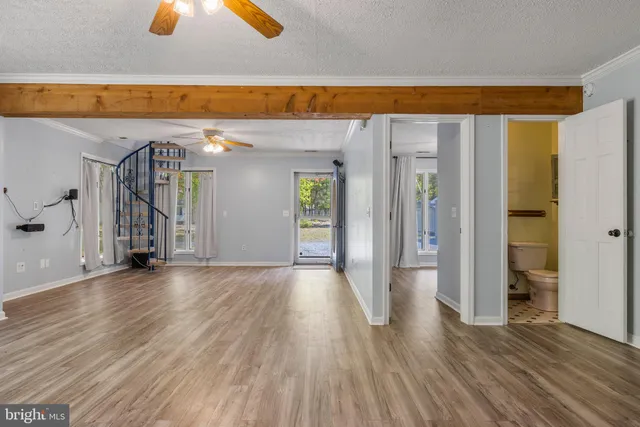 a living room with a fireplace and a large window