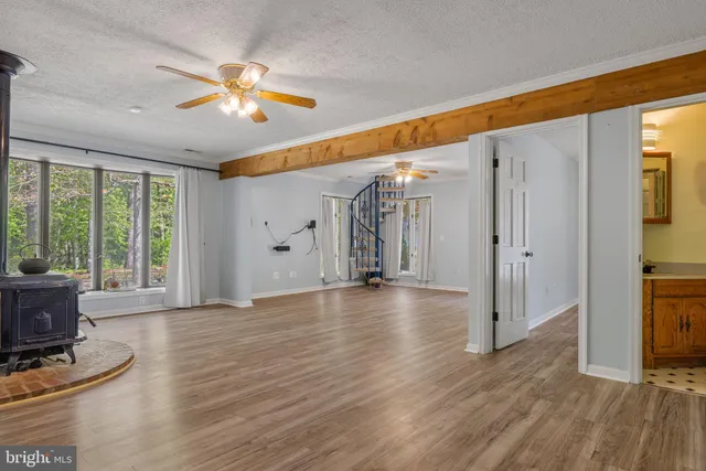 a view of room with window and wooden floor