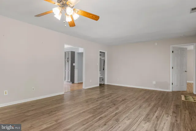 a kitchen with stainless steel appliances granite countertop a sink a stove a refrigerator and cabinets