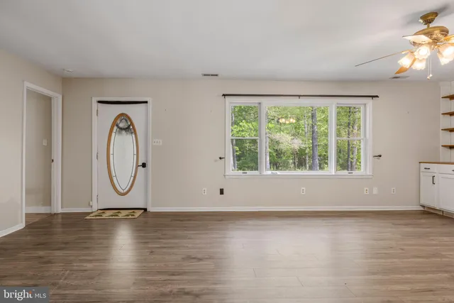 a kitchen with stainless steel appliances kitchen island granite countertop a refrigerator and microwave