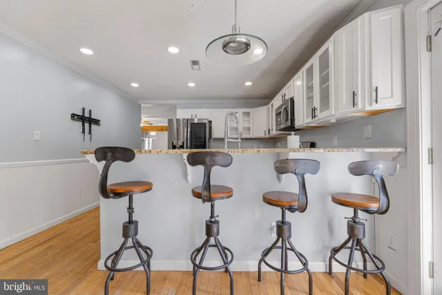a view of a livingroom with hardwood floor and a ceiling fan