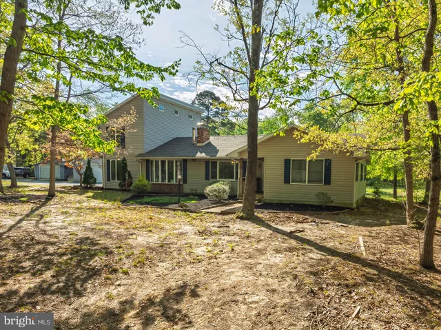 an aerial view of a house with yard swimming pool and outdoor seating