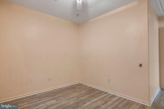 a view of a small house with a small yard and large tree