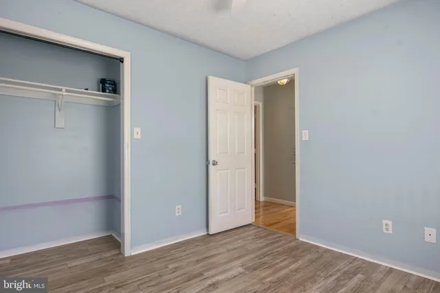 a view of a house with a big yard and large trees