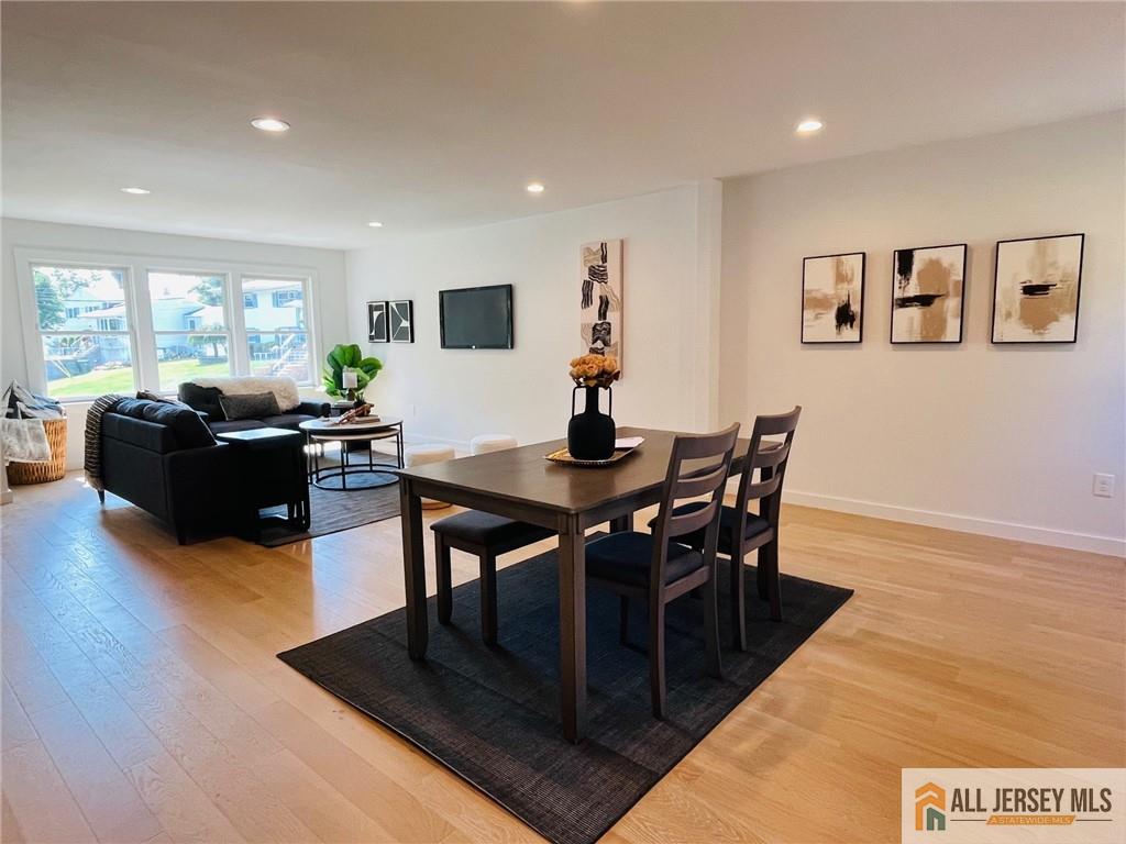 42 Larchmont Road Edison, NJ 08837 - Photo 11 of 36 a living room with furniture a wooden floor and a flat screen tv