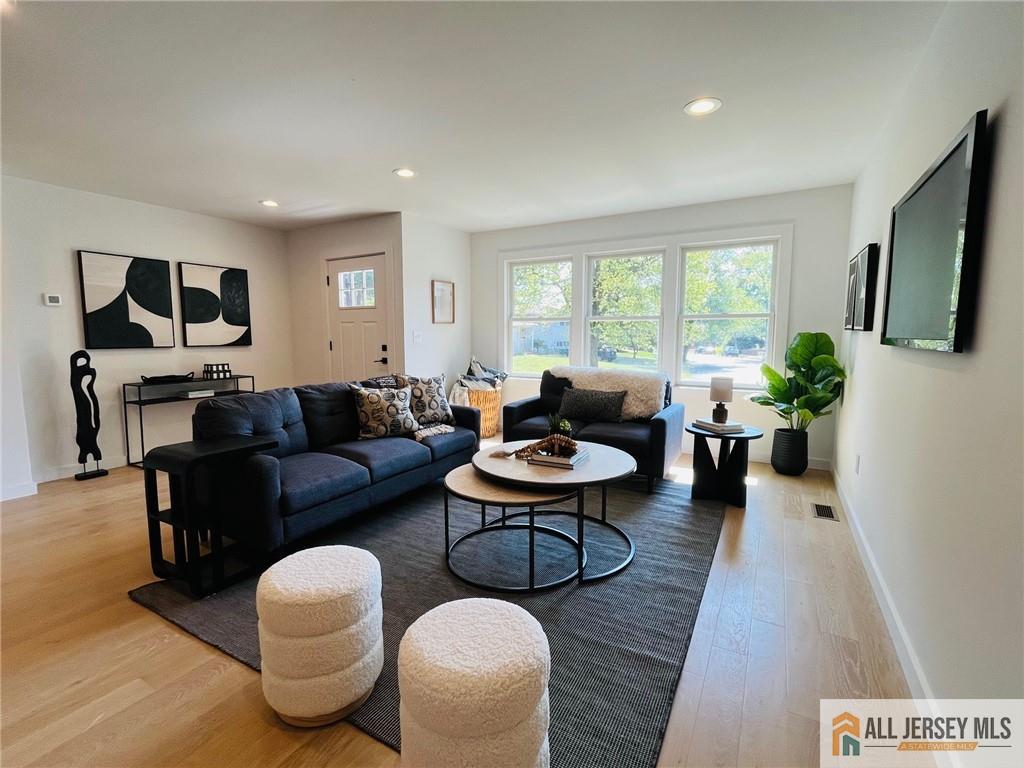 42 Larchmont Road Edison, NJ 08837 - Photo 12 of 36 a living room with furniture potted plant and a window