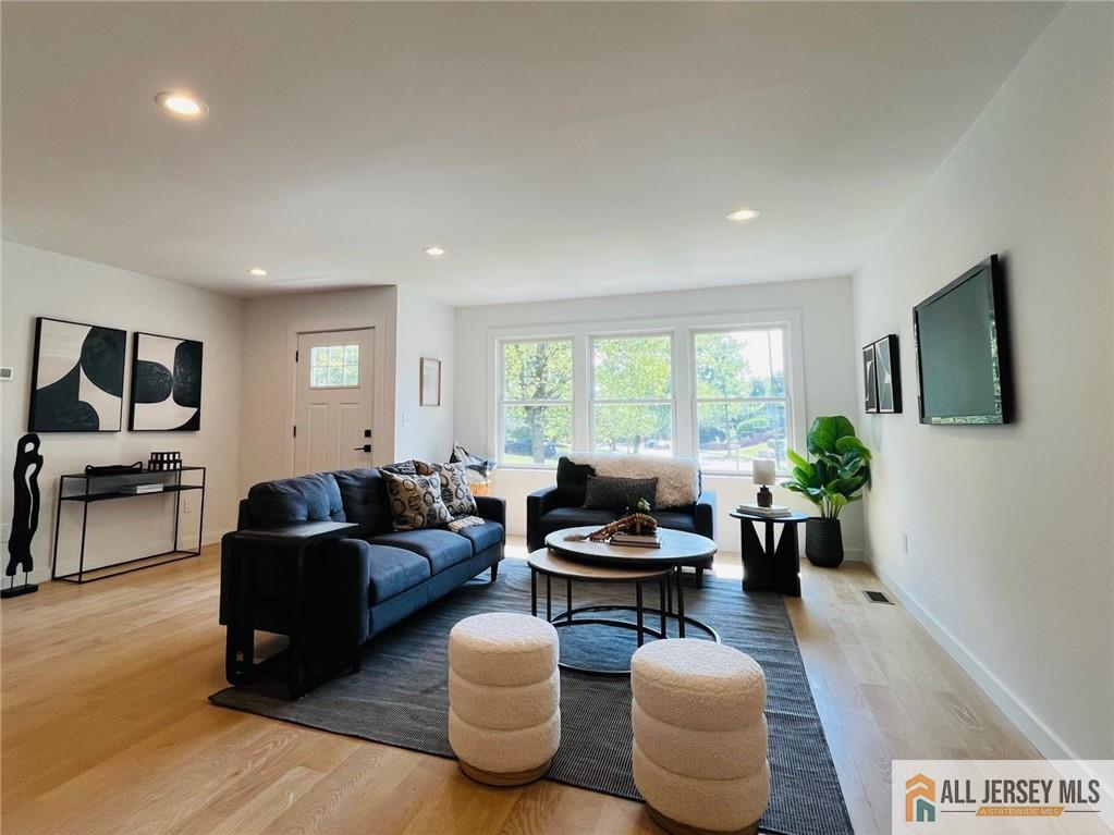 42 Larchmont Road Edison, NJ 08837 - Photo 14 of 36 a living room with furniture fireplace and a large window