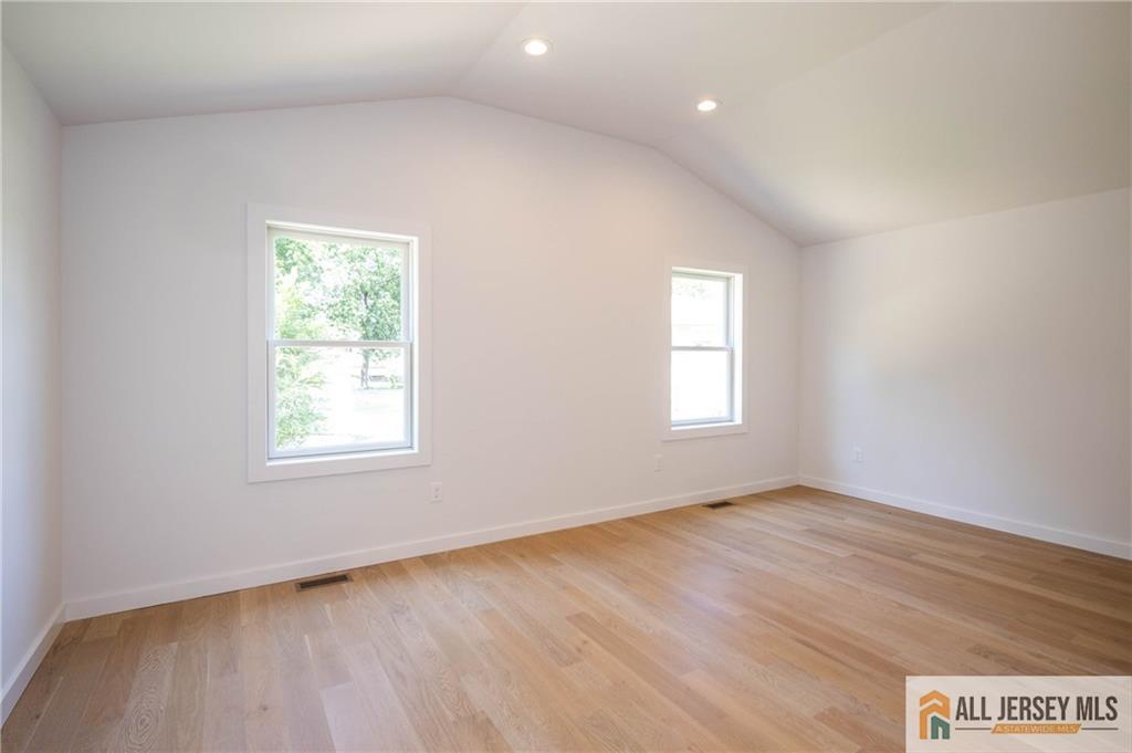 42 Larchmont Road Edison, NJ 08837 - Photo 15 of 36 an empty room with wooden floor and windows