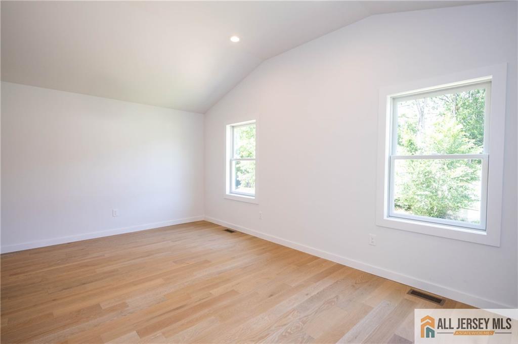 42 Larchmont Road Edison, NJ 08837 - Photo 16 of 36 an empty room with wooden floor and windows