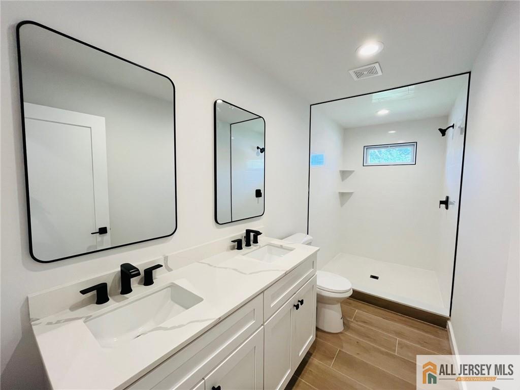 42 Larchmont Road Edison, NJ 08837 - Photo 17 of 36 a bathroom with a double vanity sink mirror double and shower