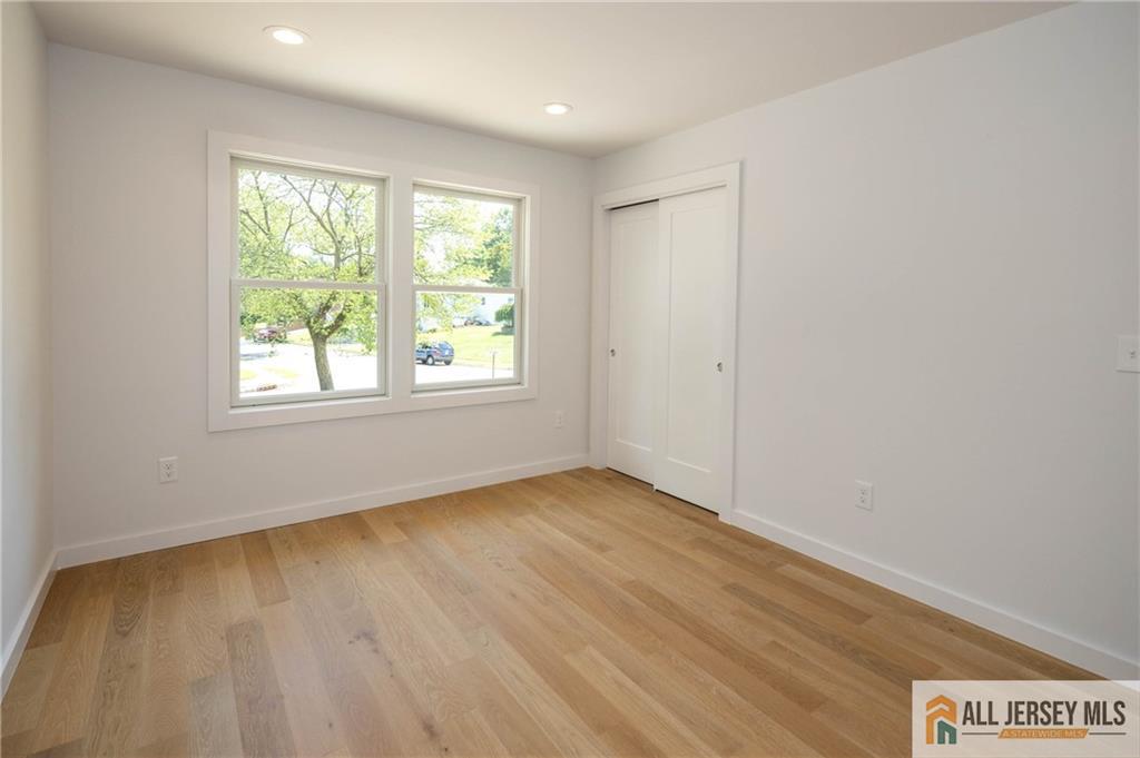 42 Larchmont Road Edison, NJ 08837 - Photo 20 of 36 an empty room with wooden floor and windows