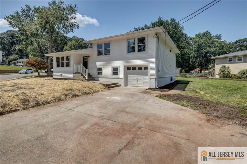 42 Larchmont Road Edison, NJ 08837 - Photo 2 of 36 a white house that has a tree in front of it