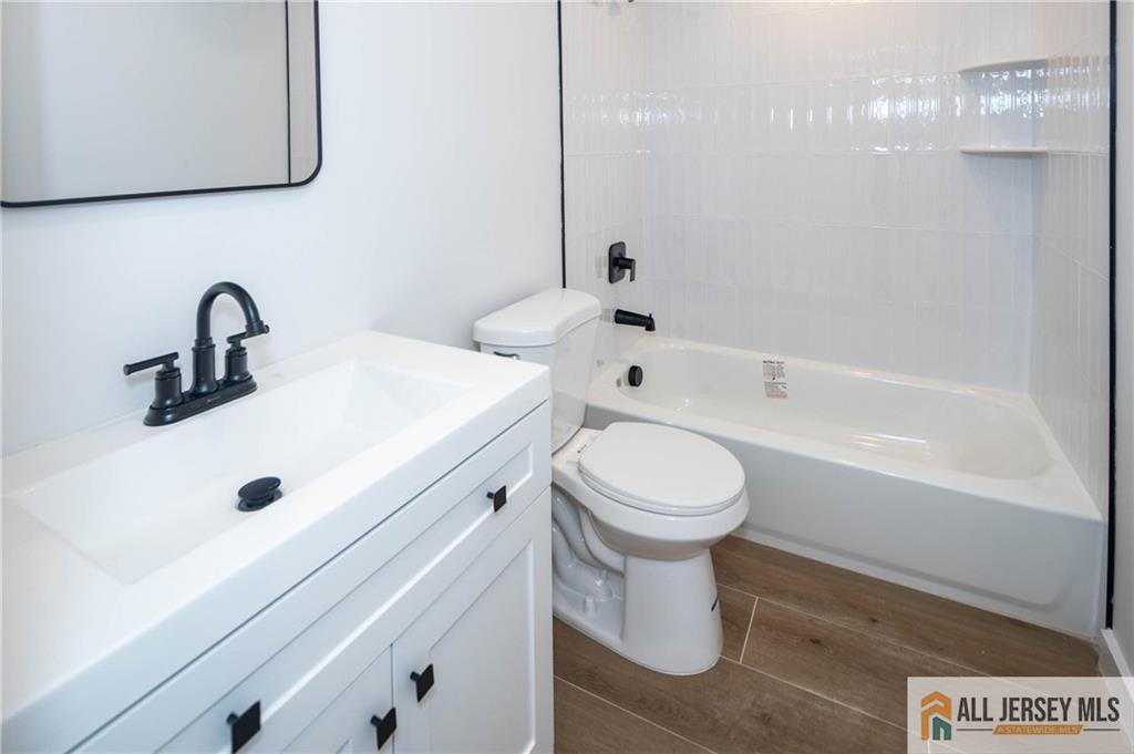42 Larchmont Road Edison, NJ 08837 - Photo 21 of 36 a bathroom with a sink a toilet and shower