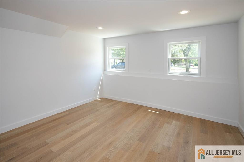 42 Larchmont Road Edison, NJ 08837 - Photo 23 of 36 an empty room with wooden floor and windows