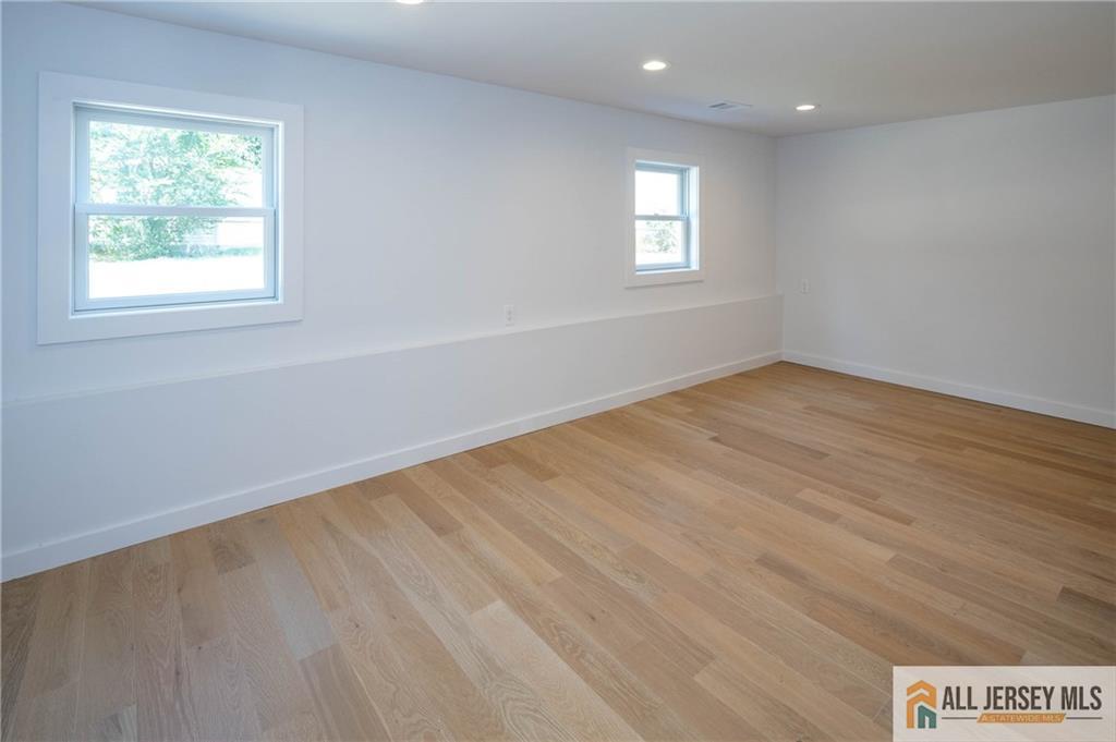 42 Larchmont Road Edison, NJ 08837 - Photo 25 of 36 an empty room with wooden floor and windows