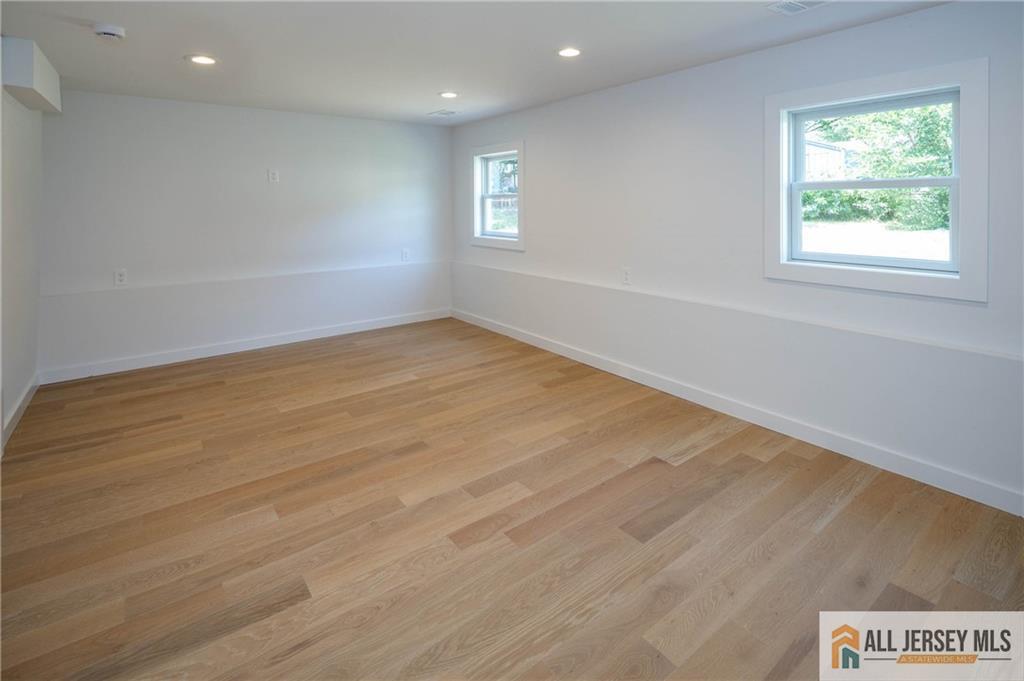 42 Larchmont Road Edison, NJ 08837 - Photo 26 of 36 an empty room with wooden floor and windows