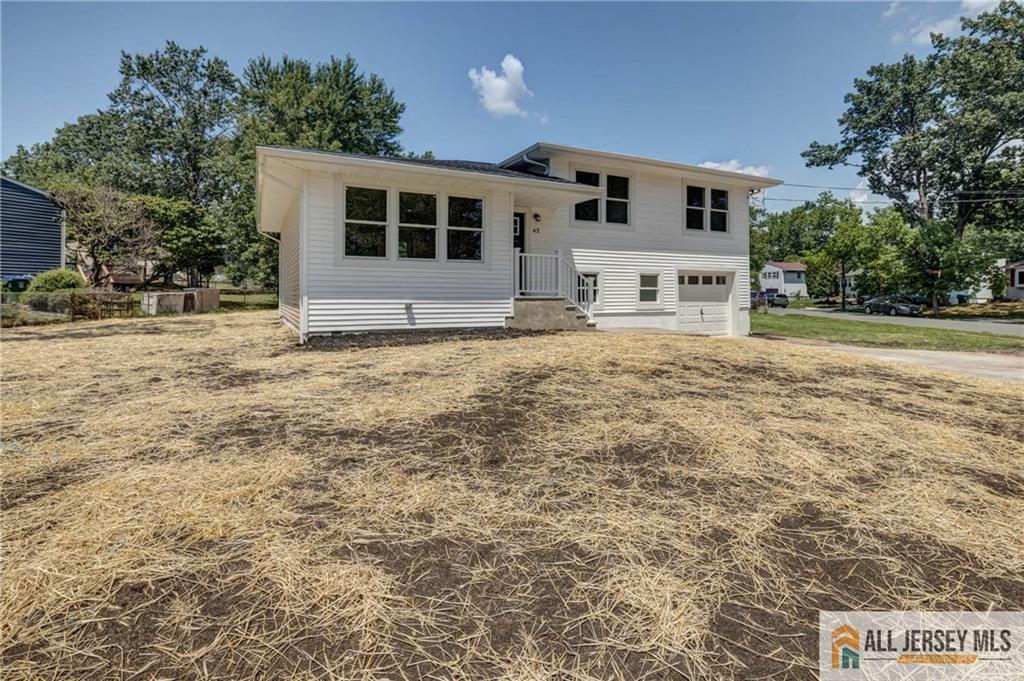 42 Larchmont Road Edison, NJ 08837 - Photo 27 of 36 a large house with a yard and parking space