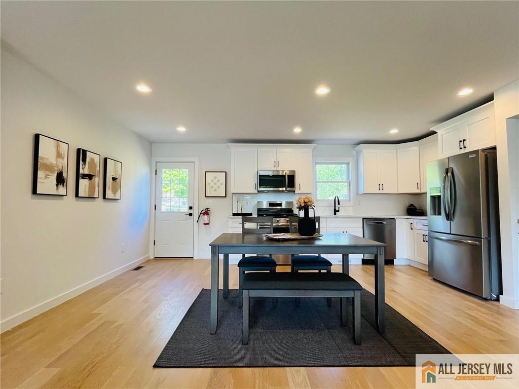 42 Larchmont Road Edison, NJ 08837 - Photo 6 of 36 a living room with furniture a kitchen view and a refrigerator