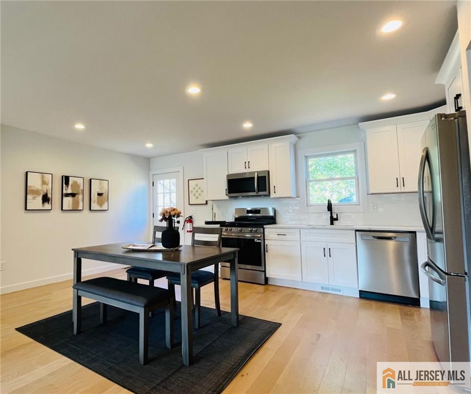 42 Larchmont Road Edison, NJ 08837 - Photo 7 of 36 a view of kitchen with cabinets table and chairs
